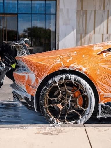 Orange Lamborghini receiving a careful exterior hand wash